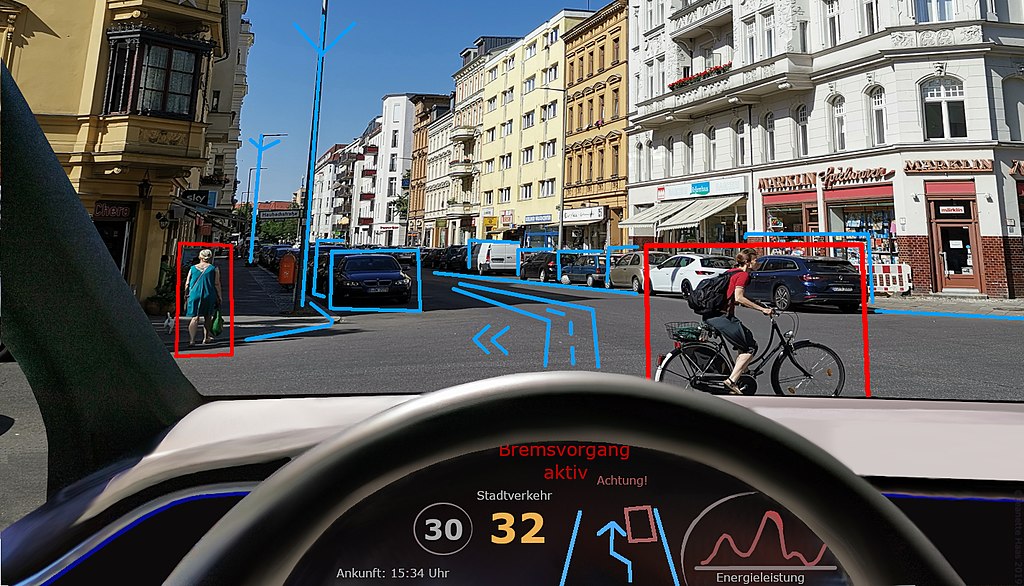 Car dashboard and view out the windscreen where bicycle, pedestrian and traffic is marked.