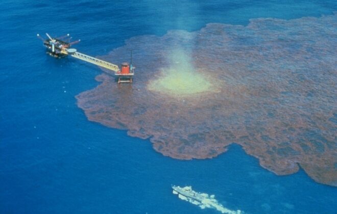Air photo of oil leaking into the sea around an oil platform.