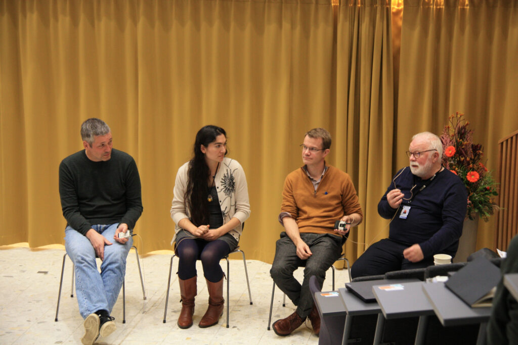 Four people speaking in a panel