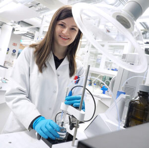 A woman looking in the camera in a lab. Photo