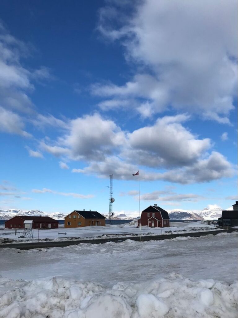 buildings in snowy landscape, blue sky. photo