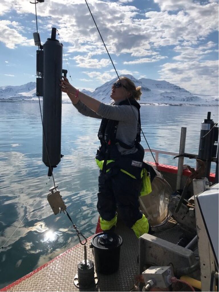 person in fishing gear on a boat. photo