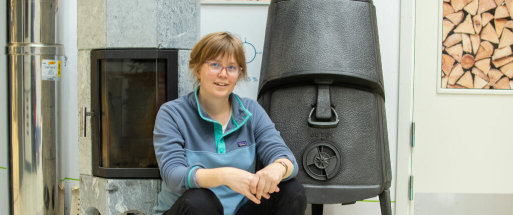 researcher in front of woodstove ovens. photo