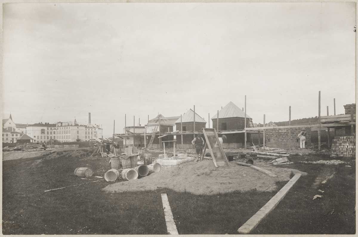 Photograph showing test houses under construction.