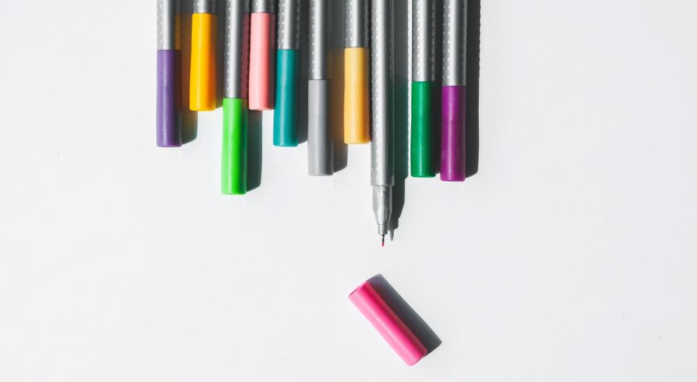 Coloured pencils in a line. Photo.